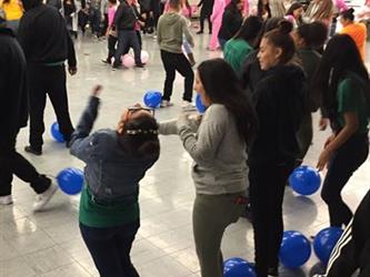 students laughing - blue balls on floor